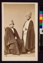 [Two men in robes and large hats]