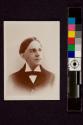 [A man in suit with a cravat]