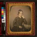 [Young woman with elbow on book]