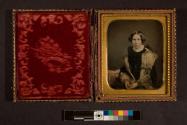 [Woman wearing fur stole and cuffs]