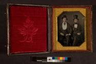 [Two men wearing hats]