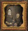 [Woman (wearing tinted glasses) and child]