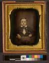 [Boy holding hat with tassel]