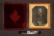 [Portrait of a man with hand in jacket]