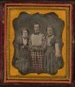 [Portrait of two women and man in checkered suit]