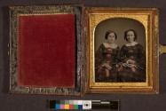 [Two women in plaid dresses]