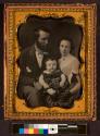 [Man, woman and child, seated]