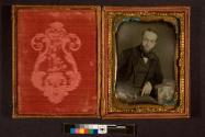 [Bearded man in suit, seated]