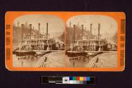 [Two steamboats on a river by the shore.]