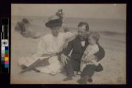 [Family sitting on beach]