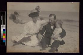 [Family sitting on beach]