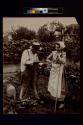 [Man and woman working in garden]