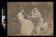 [Two women sitting outside at table drinking wine and beer]