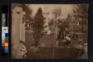 Planting flowers on the grave of a union veteran on Decoration Day.
