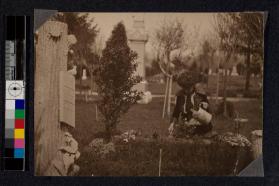 Planting flowers on the grave of a union veteran on Decoration Day.
