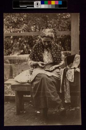 [Woman sitting on bench holdng coins]