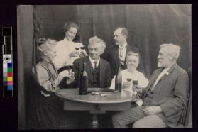 [Six people around table toasting with wine glasses]