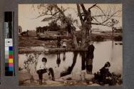[Children standing in front of lake]