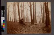 [Man and woman sitting in forrest reading]
