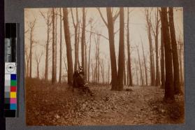[Man and woman sitting in forrest reading]