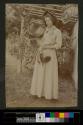 [Woman holding large sunflower]