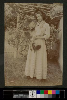 [Woman holding large sunflower]