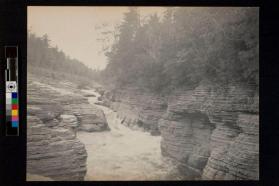 [River cutting through layered rocks]