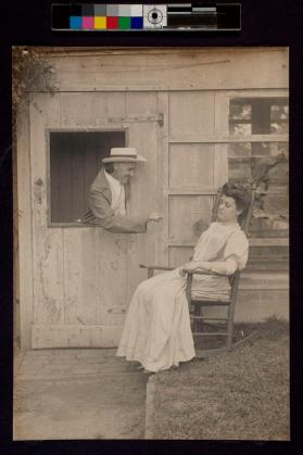 [Man leaning out of window bothering woman resting in chair]