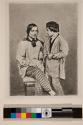 [Portrait of seated man, boy standing by his side]