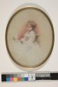 [Seated young woman in white dress]