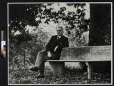 George Eastman Sitting at his Octagonal Bench Surrounding Shagbark Hickory Tree