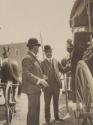 Men talking beside carriage, Western Trip