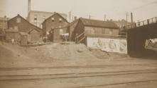 Buildings beside railroad tracks, Western Trip