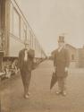 George Eastman and unidentified man beside train, Western Trip