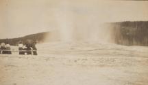 Group viewing Yellowstone geyser from bench, Western Trip