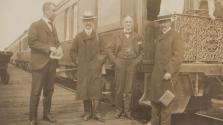 Edward Mulligan, George Eastman and two unidentified men near train, Western Trip