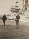 Men walking beside ship, Western Trip