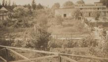 View of railroad tracks, gardens and buildings, Western Trip