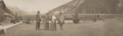 Mulligans and Hubbells posing in front of train and mountains, Western Trip