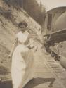 Woman walking beside railroad tracks, Western Trip