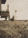 Man sitting on railroad tracks beside caboose, Western Trip