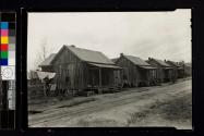 [Row of small wooden houses]