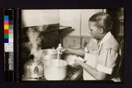 [African American woman at stove]