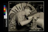 [Man and micrometer]
