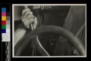 [At the control wheel...]