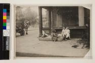 Idle children tending little ones. Street-corner group, New York City