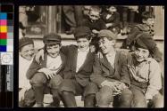[Group of boys seated on steps]