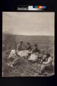 [Field workers at rest by edge of field]