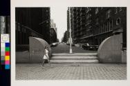 Woman passing rounded cement walls