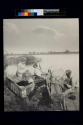 [People on dock with bow-nets]